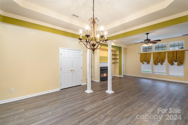 unfurnished living room with hardwood / wood-style flooring, a raised ceiling, crown molding, and ornate columns