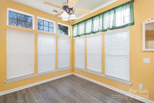 unfurnished sunroom featuring ceiling fan