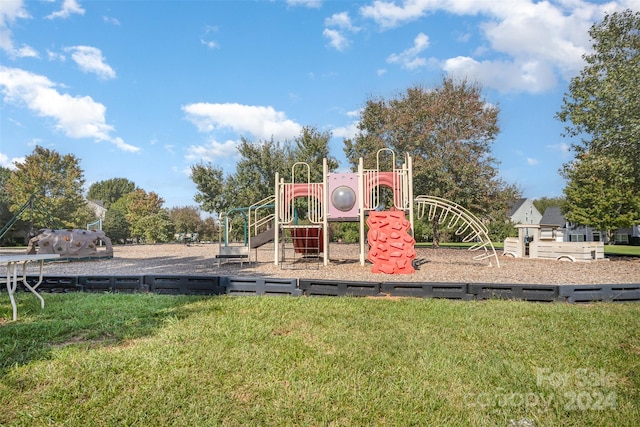 view of jungle gym featuring a lawn