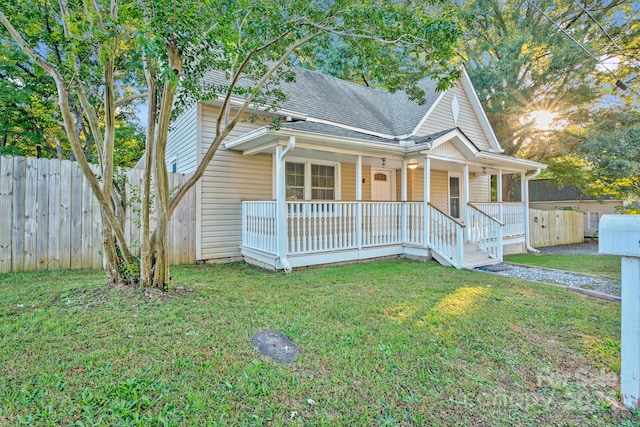 view of front of house featuring a front lawn and covered porch