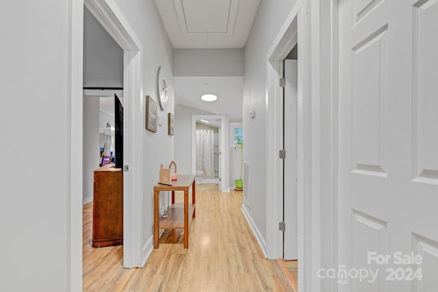 corridor with light hardwood / wood-style flooring