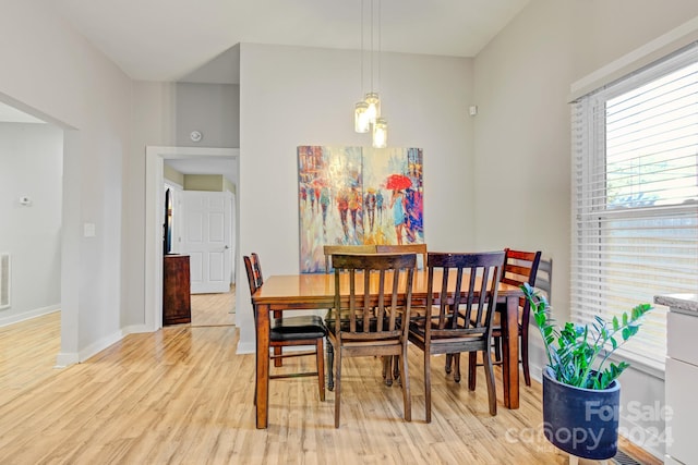 dining space with light hardwood / wood-style floors