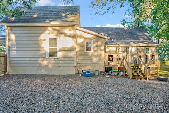 back of house with a wooden deck