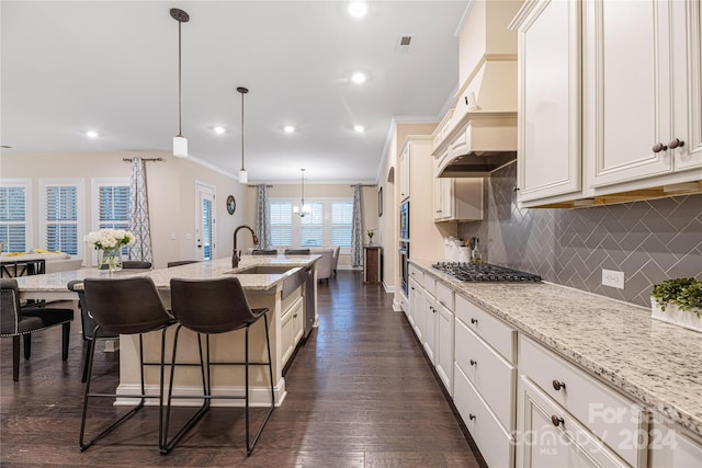 kitchen featuring pendant lighting, light stone countertops, dark wood-type flooring, and crown molding