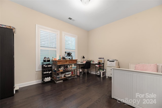 bedroom with dark hardwood / wood-style floors