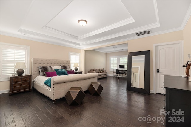 bedroom featuring crown molding, a tray ceiling, and dark hardwood / wood-style floors