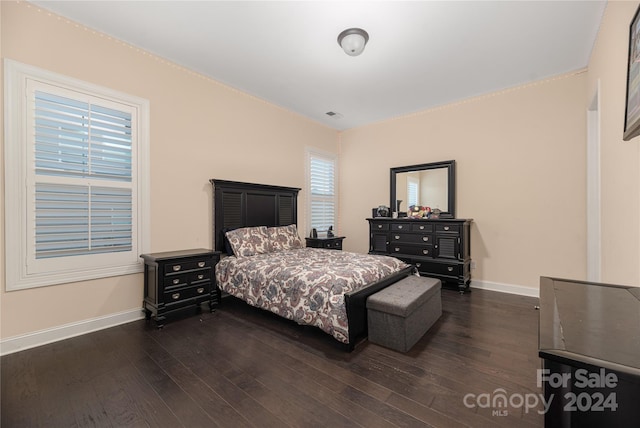 bedroom with dark wood-type flooring