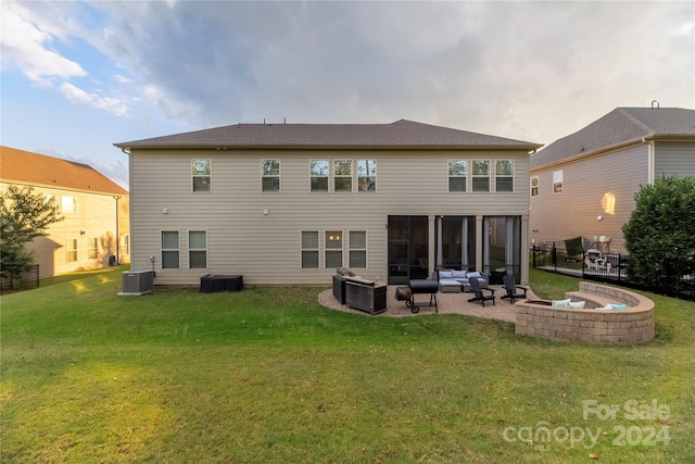 rear view of property with a lawn, a patio, central AC, and outdoor lounge area