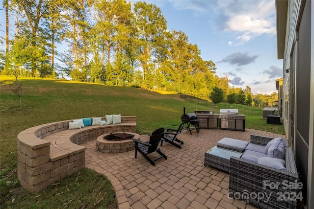 view of patio with area for grilling and an outdoor fire pit