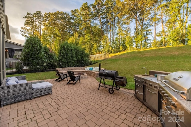 patio terrace at dusk with a lawn and a grill