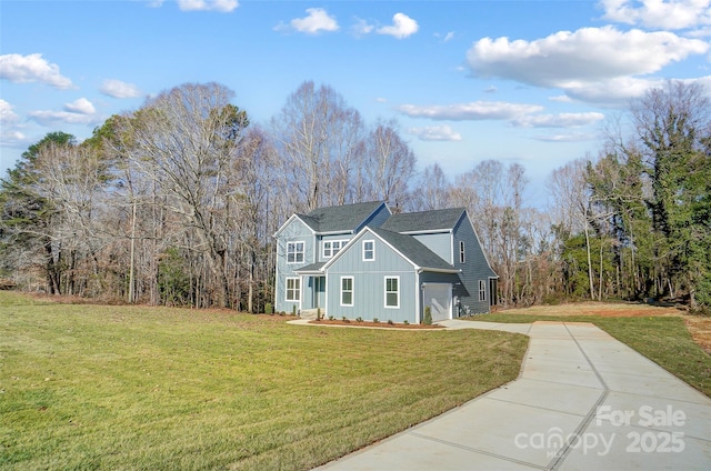 view of front of home with a front yard and a garage