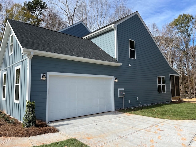 view of home's exterior featuring a garage and a yard