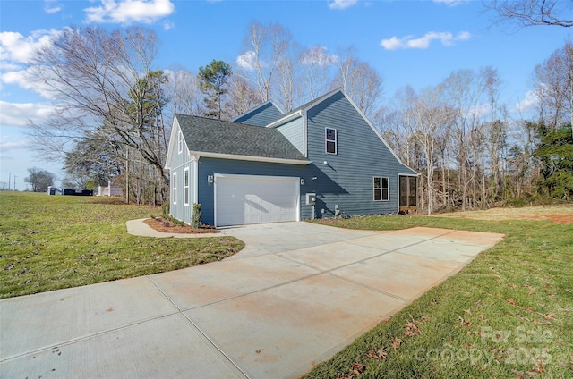 view of side of property with a lawn and a garage