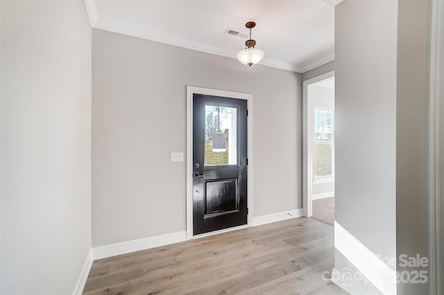 entrance foyer with light wood-type flooring and crown molding