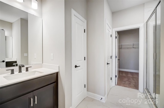 bathroom with vanity and a shower with shower door