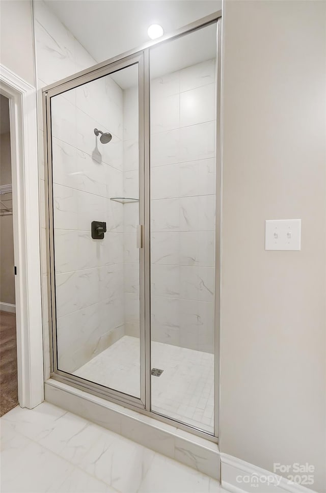 bathroom with a shower with shower door