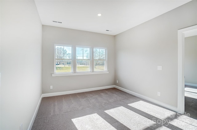 unfurnished room featuring light colored carpet