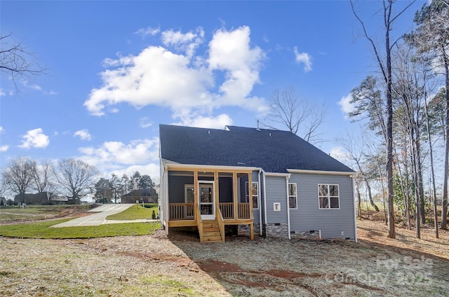 back of house featuring a lawn and a sunroom