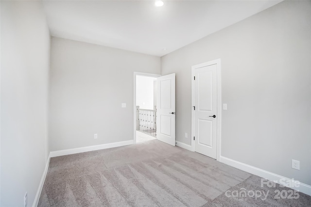 unfurnished room with light carpet