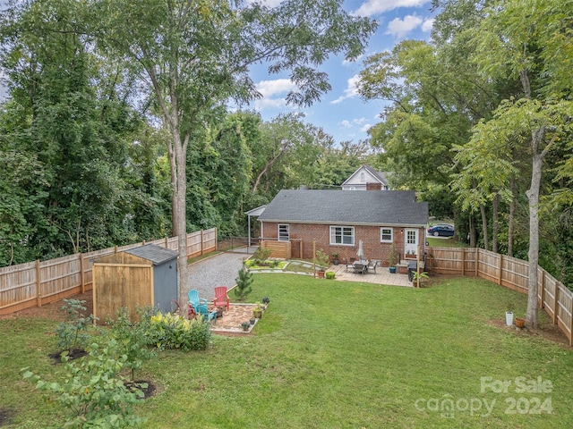 back of house with a lawn, a patio area, and a shed