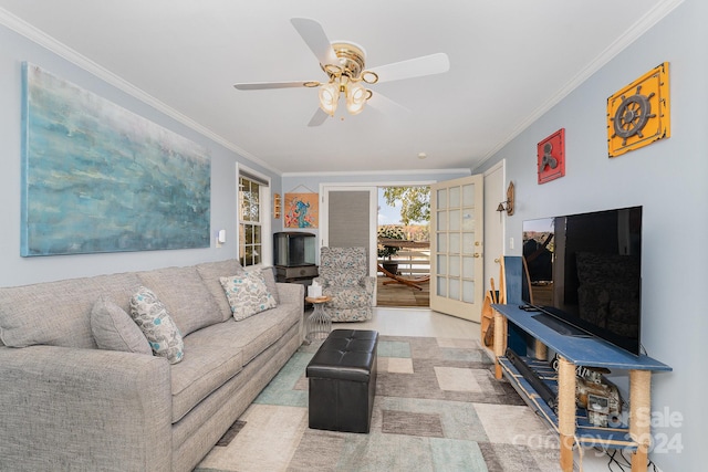 living room with crown molding, light wood-type flooring, and ceiling fan