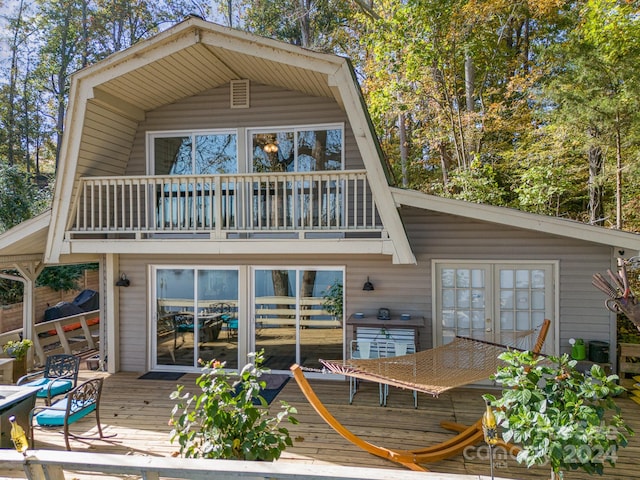 back of house with a wooden deck