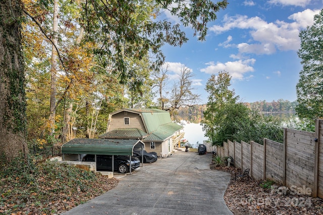 view of side of property featuring a water view and a carport