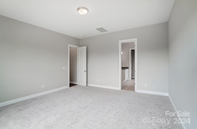 spare room with light colored carpet