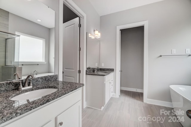 bathroom with vanity and plus walk in shower