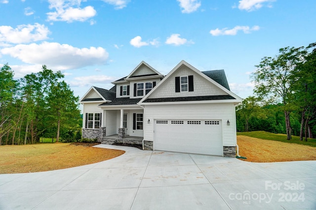 craftsman-style house with a front yard and a garage