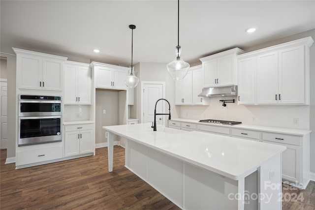 kitchen with pendant lighting, white cabinetry, stainless steel appliances, and dark hardwood / wood-style floors