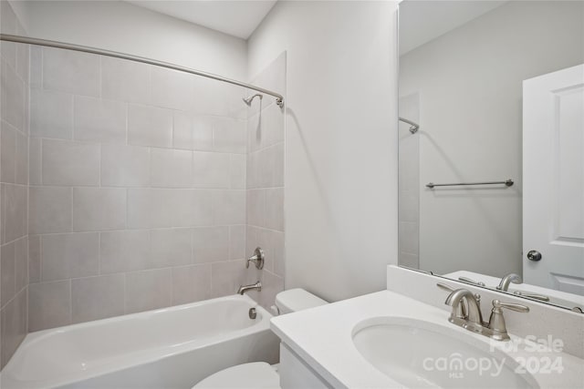 full bathroom with vanity, toilet, and tiled shower / bath