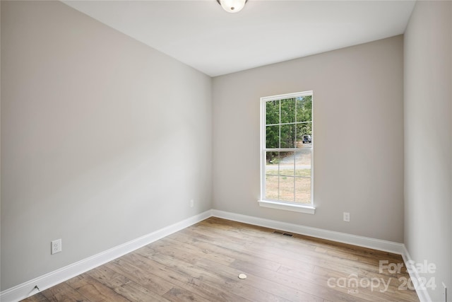 unfurnished room with light hardwood / wood-style flooring