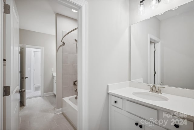 bathroom featuring vanity, tiled shower / bath, and tile patterned flooring