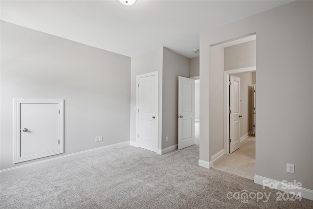 unfurnished bedroom featuring light colored carpet