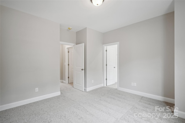 unfurnished bedroom featuring carpet floors and baseboards