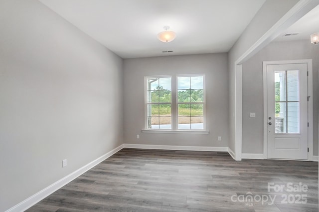 entrance foyer with plenty of natural light, wood finished floors, and baseboards