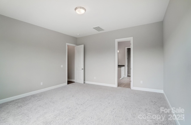 unfurnished bedroom featuring baseboards, visible vents, and carpet flooring