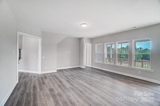 552 Fern Hill Rd Unit 21, Mooresville, NC 28117 - unfurnished living room with wood finished floors and baseboards