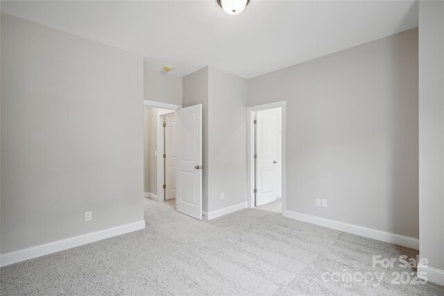 552 Fern Hill Rd Unit 21, Mooresville, NC 28117 - unfurnished bedroom with carpet and baseboards