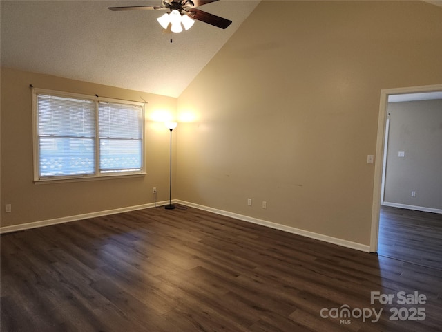 spare room featuring ceiling fan, dark wood-type flooring, and high vaulted ceiling