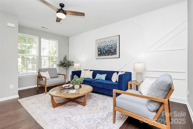 living room with ceiling fan and dark hardwood / wood-style floors