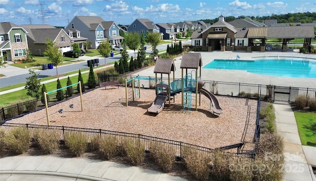 view of playground featuring a community pool