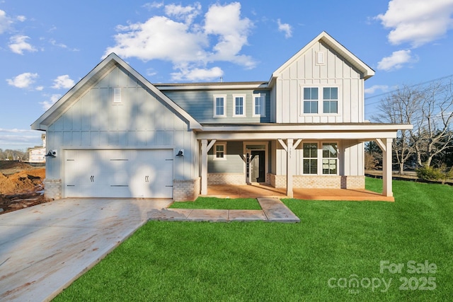 view of front of home featuring covered porch, a garage, and a front lawn