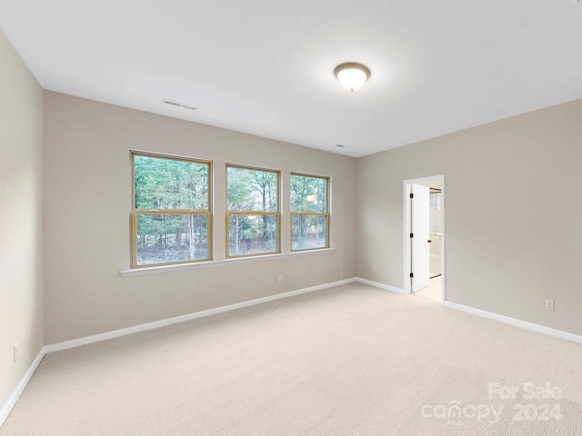 unfurnished room with light colored carpet