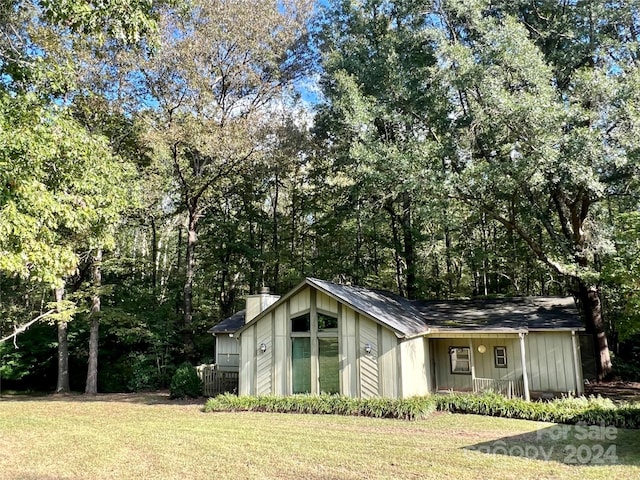 view of outdoor structure featuring a lawn