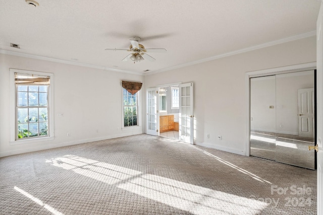 unfurnished bedroom with crown molding, baseboards, carpet flooring, and ensuite bath