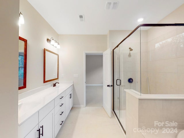 bathroom featuring vanity and a shower with door