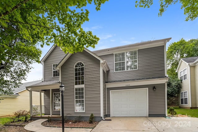 front facade with a garage and covered porch