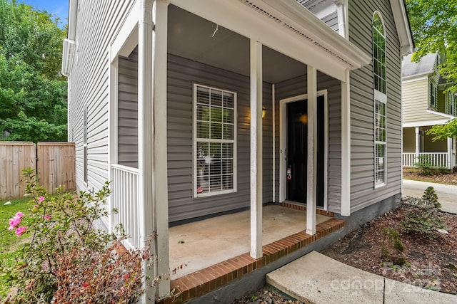 view of exterior entry with covered porch